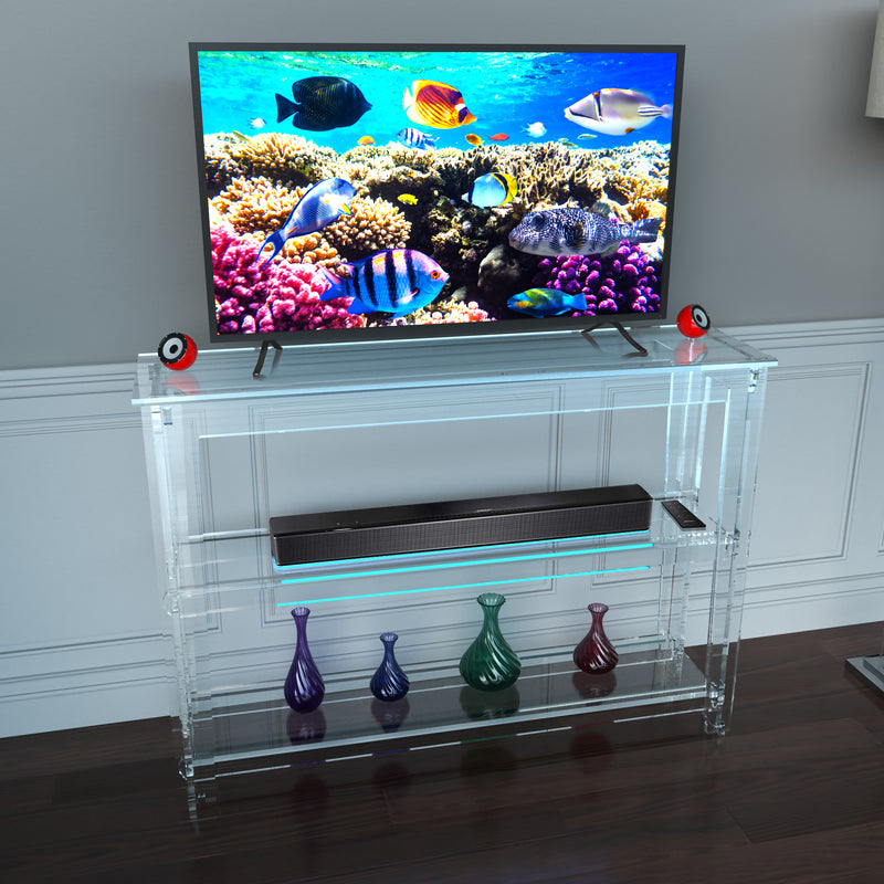 tv clear acrylic console with speakers and vases
